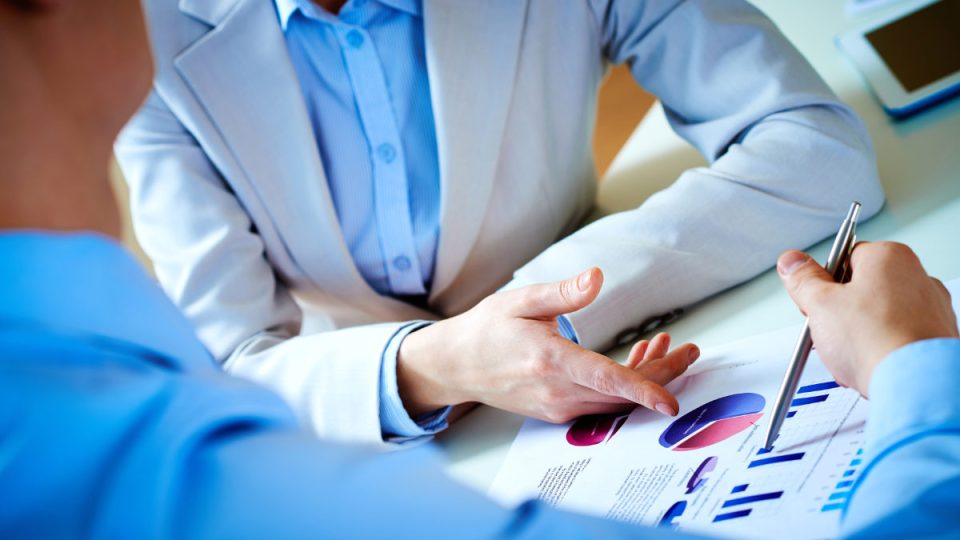 At meeting Close-up of female and male hands pointing at business document while discussing it