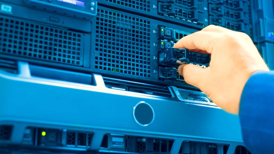 IT engineer repairing a server in a datacenter IT engineer repairing a server in a datacenter .
